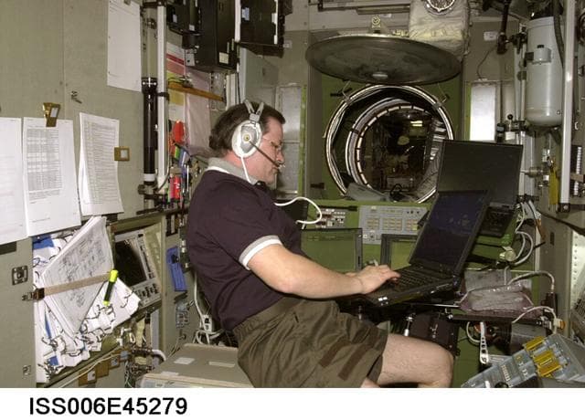 NASA image: Flight Engineer Budarin uses a laptop computer in the SM during Expedition Six