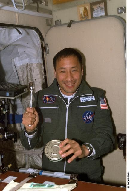 NASA image: Edward T. Lu prepares to eat a meal in the SM