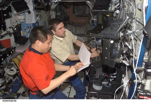 NASA image: Expedition Seven CDR Malenchenko and Sciece Officer Lu at SSRMS controls
