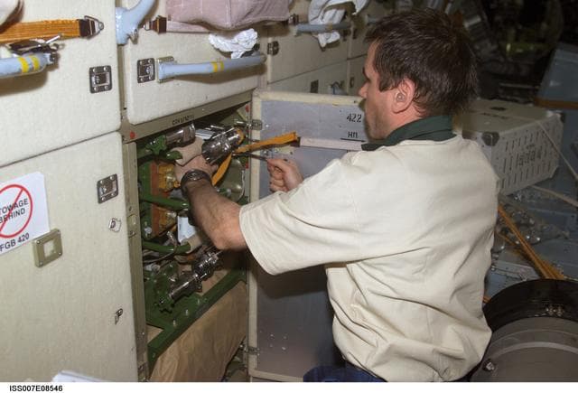 NASA image: Expedition Seven CDR Malenchenko during maintenance task in the FGB