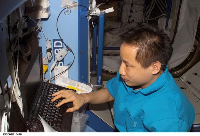 NASA image: Expedition Seven Science Officer Lu with laptop