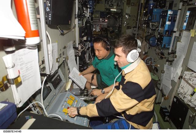 NASA image: Expedition Seven Malenchenko and Lu at Simvol-Ts controls in Zvezda module