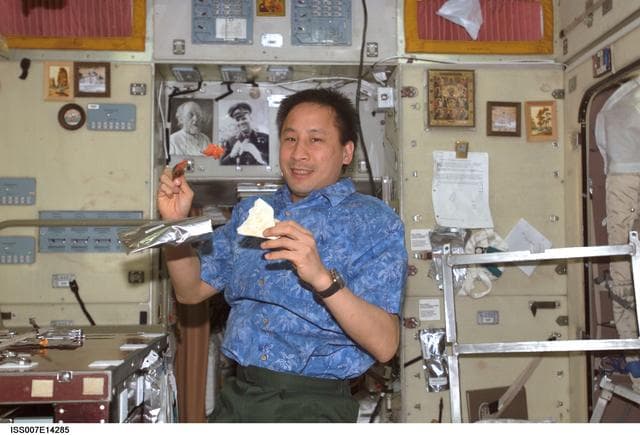 NASA image: Expedition Seven Lu eating in Zvezda Service module
