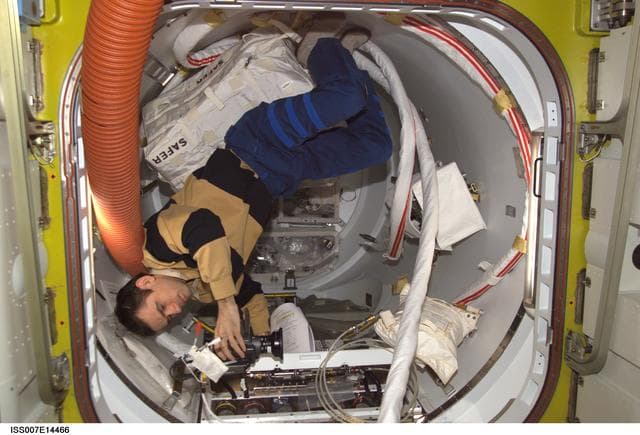 NASA image: Expedition Seven Malenchenko with video camera in Quest airlock