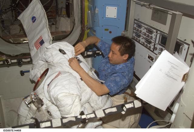 NASA image: Expedition Seven Lu with EMU in Quest airlock