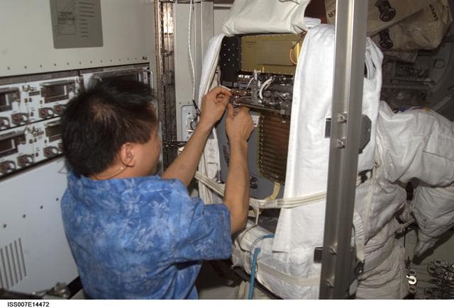 NASA image: Expedition Seven Lu with EMU in Quest airlock