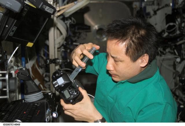 NASA image: Expedition Seven Lu performs maintenance on camera