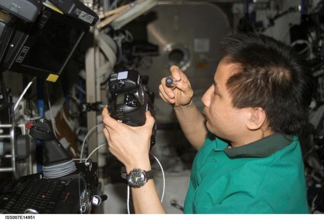 NASA image: Expedition Seven Lu performs maintenance on camera