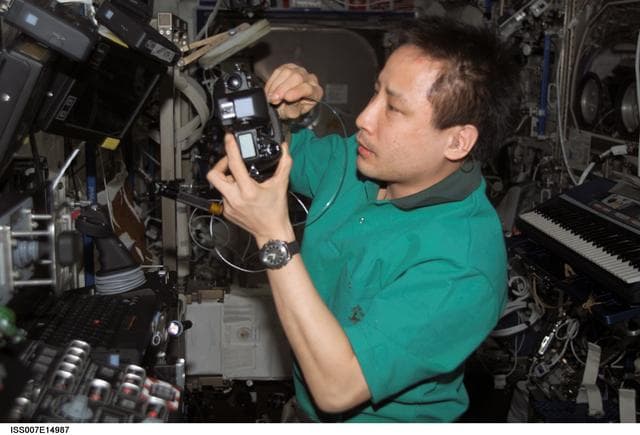 NASA image: Expedition Seven Lu performs maintenance on camera
