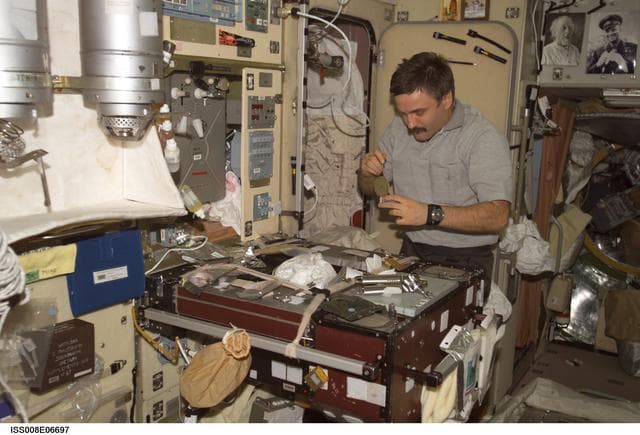 NASA image: Kaleri prepares a meal in the galley area of the SM during Expedition 8