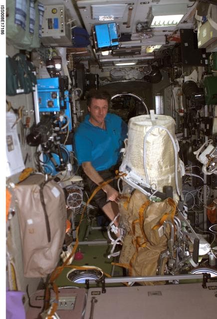 NASA image: Foale poses beside the Expedition 8 EVA bundle in the SM