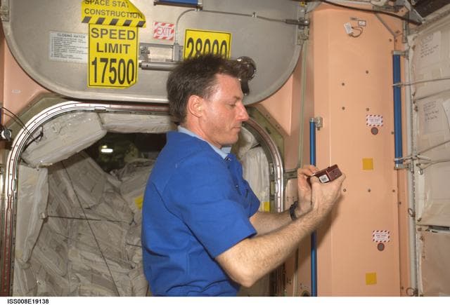 NASA image: Foale works with the SPHERES Beacon / Beacon Tester in Node 1 during Expedition 8