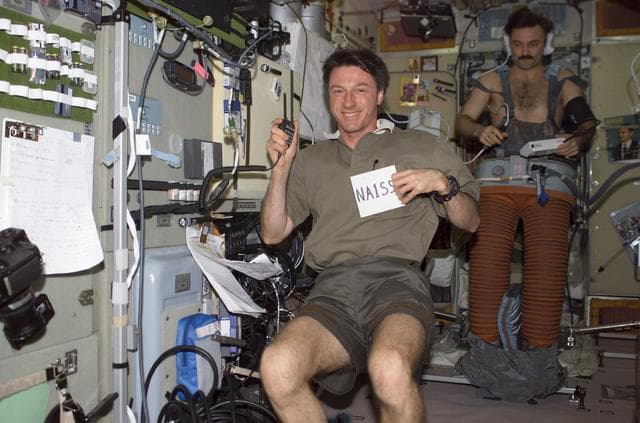 NASA image: Foale at the ARISS ham radio station and Kaleri in Chibis LBNP suit in SM during Expedition 8