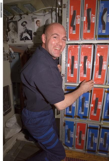 NASA image: Kuipers retrieves a food locker at mealtime in the SM during EXP 8 / EXP 9