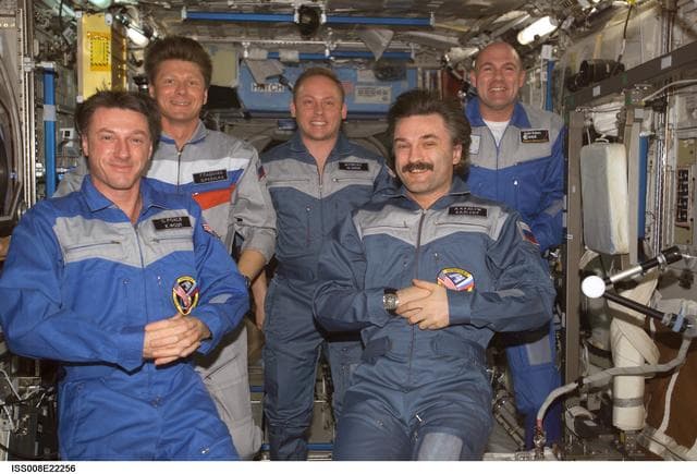 NASA image: Expedition 8 and Expedition 9 crews pose for a group photo in the U.S. Laboratory