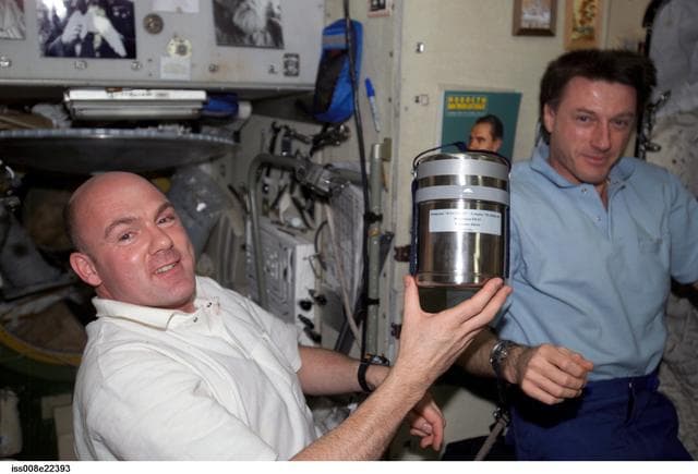 NASA image: Kuipers holds the Plasma-03 experiment container as Foale looks on during Expedition 9 / Expedition 8