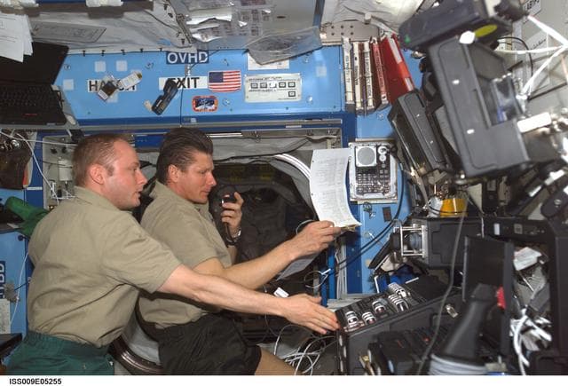 NASA image: Padalka and Fincke participate in planning conference with Mission Control in the U.S. Laboratory during Expedition 9