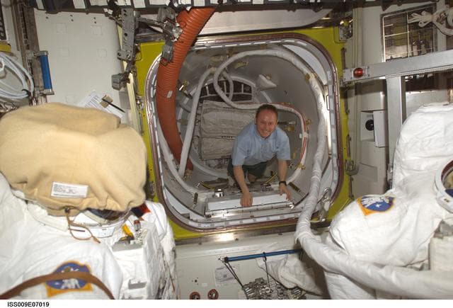 NASA image: Fincke inside the Crew Lock area of the Quest Airlock during Expedition 9