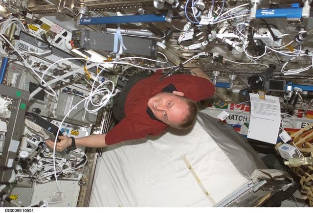 NASA image: Fincke unstows a spare RPCM from the U.S. Lab during Expedition 9