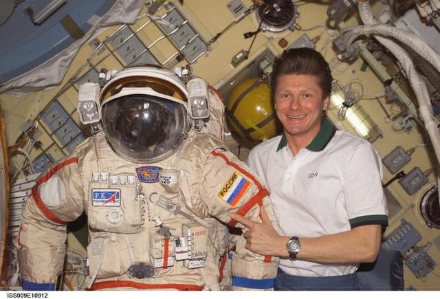 NASA image: Padalka poses with an Orlan EVA suit inside the Pirs DC during Expedition 9