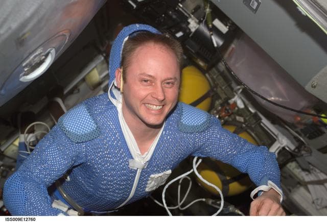 NASA image: Fincke smiles at the camera before donning his EVA suit in the DC during Expedition 9