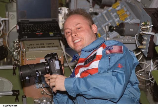 NASA image: Fincke holds a digital camera in the SM during Expedition 9