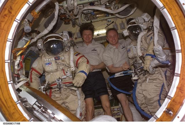 NASA image: Padalka and Fincke pose with their Orlan Suits inside the Docking Compartment during Expedition 9