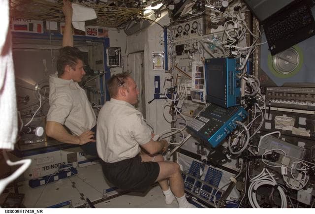 NASA image: Fincke performs an ultrasound bone scan on Padalka using the ADUM in the U.S. Lab during Expedition 9