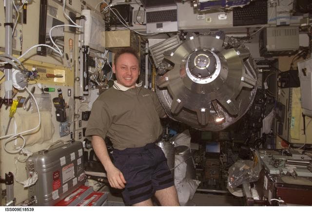 NASA image: Fincke holds the active docking assembly inside the SM during Expedition 9