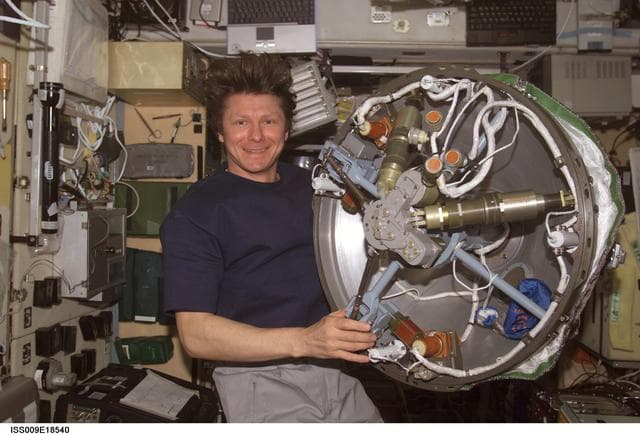 NASA image: Padalka holds the active docking assembly inside the SM during Expedition 9