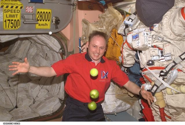 NASA image: Fincke watches apples and a tennis ball float in the Service Module during Expedition 9