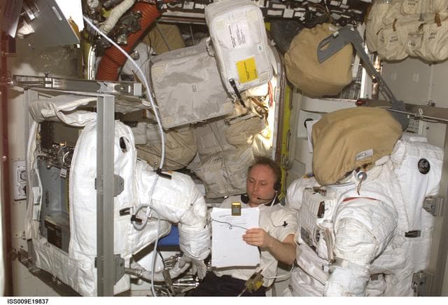 NASA image: Fincke conducts cooling tests on EMU during repair operations in the A/L on Expedition 9