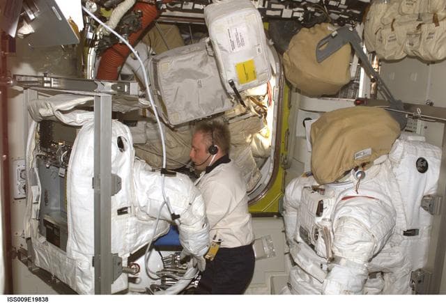 NASA image: Fincke conducts cooling tests on EMU during repair operations in the A/L on Expedition 9