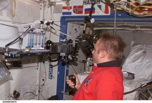 NASA image: Fincke works on the CFE experiment in the U.S. Lab during Expedition 9