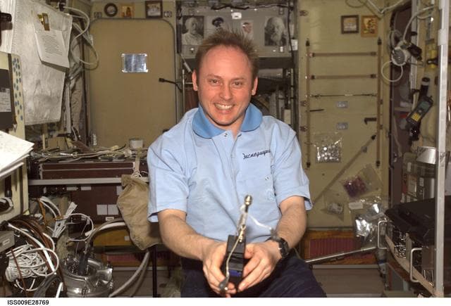 NASA image: Fincke collects air samples in the SM using the DST during Expedition 9