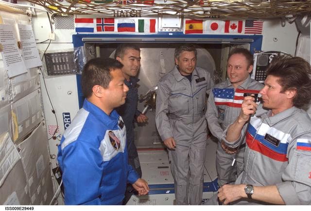 NASA image: Expedition 9 and 10 crews positions themselves for the Change-of-Command Ceremony in the U.S. Lab