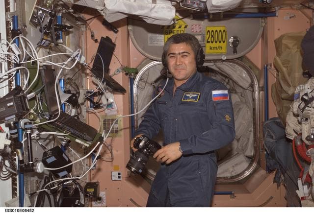 NASA image: Sharipov holds a still camera in the Node 1 during Expedition 10