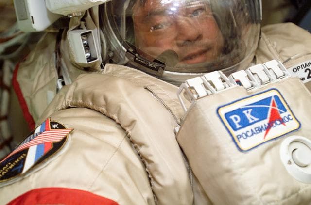 NASA image: Sharipov wearing an EMU in the Airlock during Expedition 10