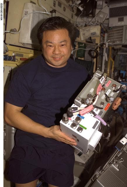 NASA image: Chiao holds an Electronic Box Assembly from the TVIS in the SM during Expedition 10