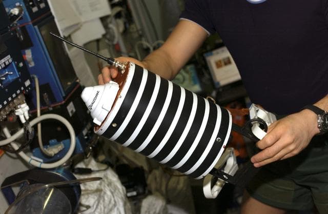 NASA image: Sharipov holds Nanosputnik in the SM during Expedition 10