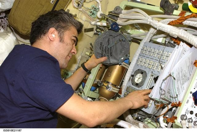 NASA image: Sharipov makes adjust on the Russian Orlan Interface Unit in the Pirs DC1 during Expedition 10