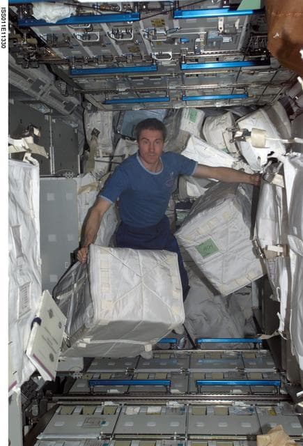 NASA image: Krkalev with stowage bags in MPLM