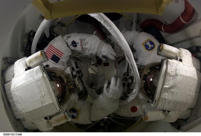 NASA image: Robinson and Noguchi in orbiter airlock for EVA 1