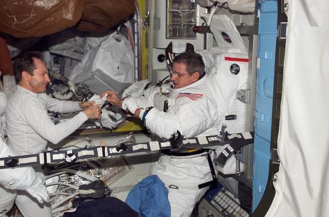 NASA image: Tokarev and McArthur conduct an EMU don/doff practice during Expedition 12