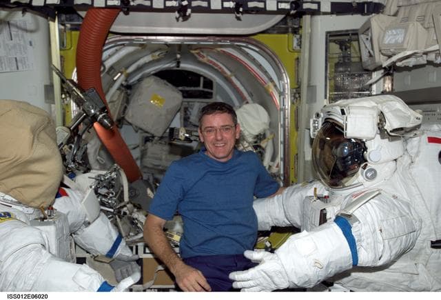 NASA image: McArthur posses with EMUs inside the Airlock during Expedition 12