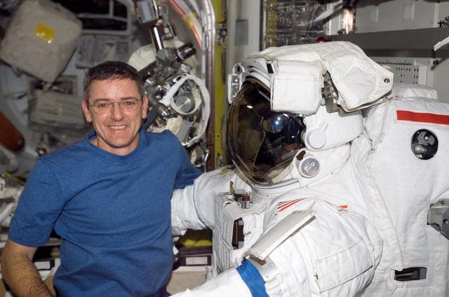 NASA image: McArthur posses with EMU inside the Airlock during Expedition 12