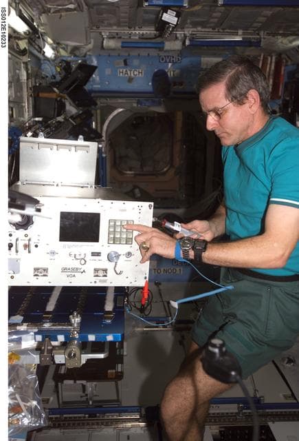 NASA image: McArthur replaces the top panels on the VOA during In-flight Maintenance on Expedition 12