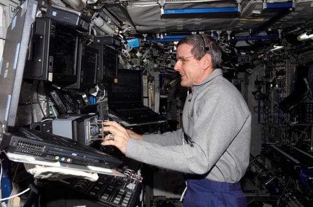 NASA image: McArthur works at the RWS during video inspection of the IUA during Expedition 12