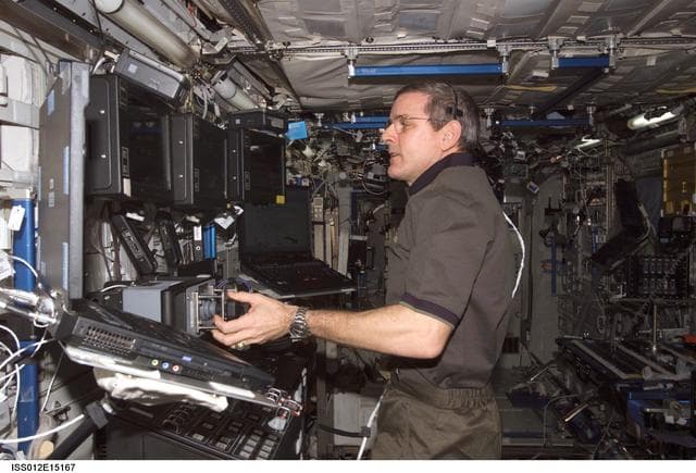 NASA image: McArthur works at the RWS surveying the ACBM during Expedition 12
