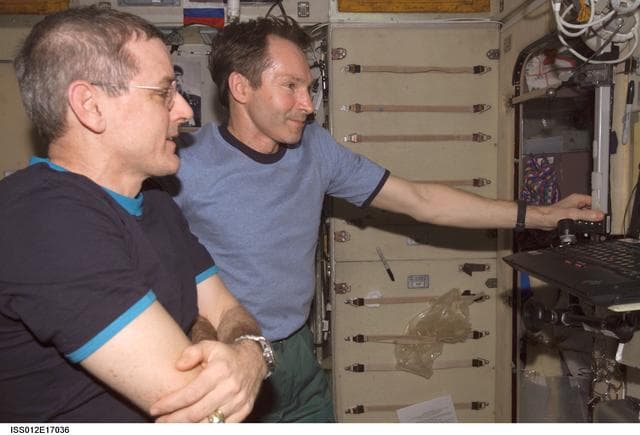 NASA image: Tokarev and McArthur watch the RadioSkaf CD on a PC after opening the SM-RadioSkaf-11.1 Kit on Expedition 12